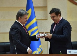 Ukraine's Petro Poroshenko hands Mikheil Saakashvili his identification card, identifying him as the new governor of the Odessa Oblast. (Press office photo)